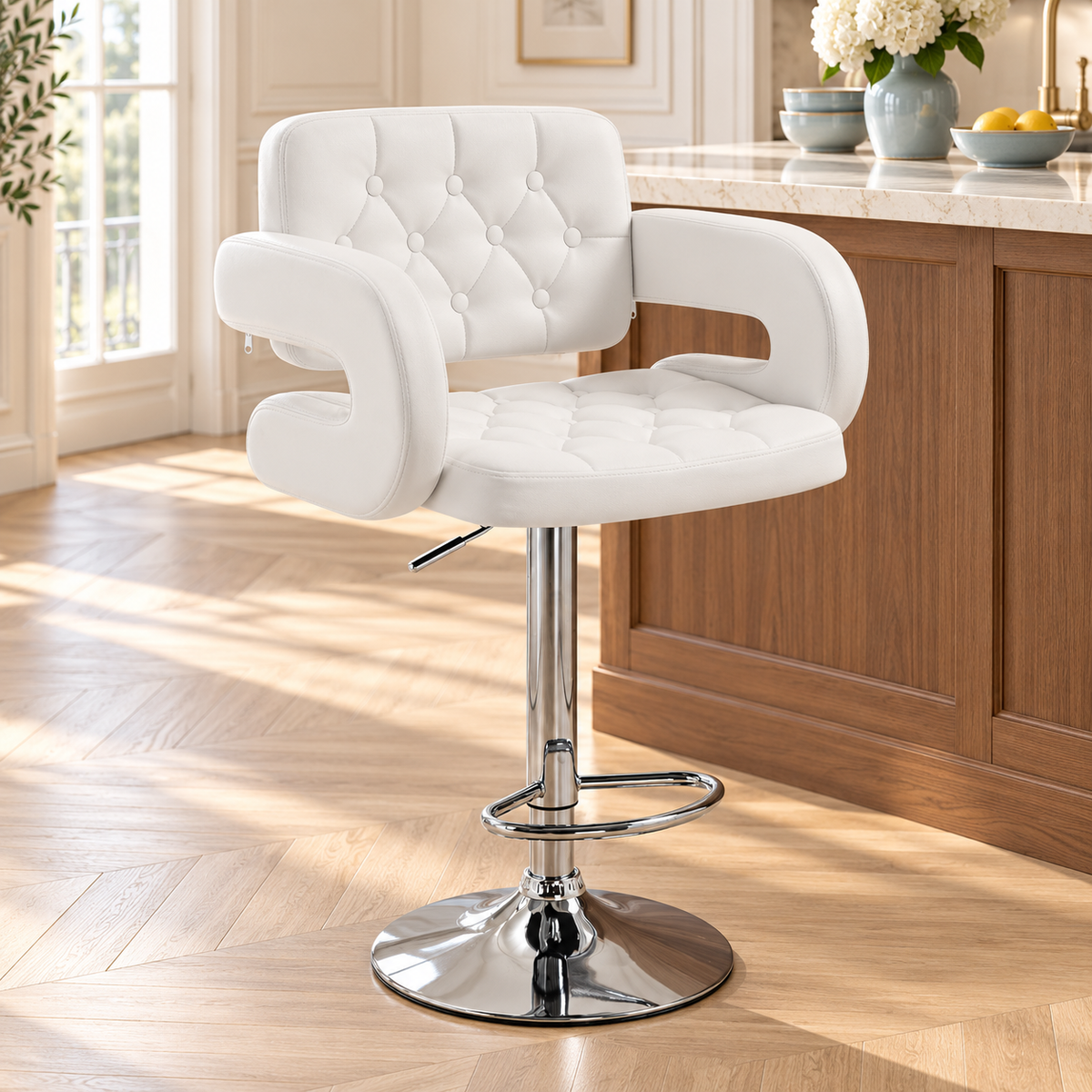 Fauteuil de bar blanc capitonné devant un îlot en bois et pierre dans une cuisine lumineuse.