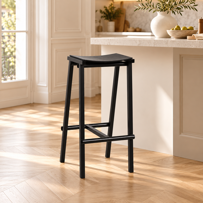 Tabouret noir de 65 cm, avec assise incurvée, dans une cuisine lumineuse.